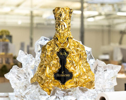 frank gehry designs sculptural gold bottle for hennessy X.O's 150th anniversary