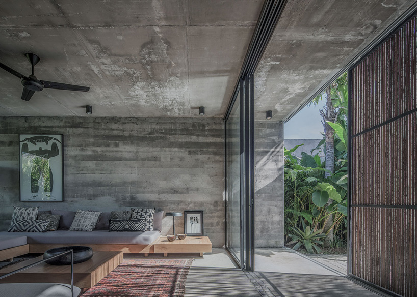 caceres + tous sets exposed concrete 'house BK' amid bali's lush natural landscape