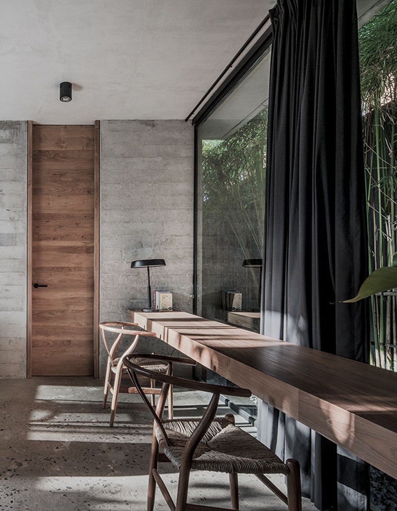 caceres + tous sets exposed concrete 'house BK' amid bali's lush natural landscape