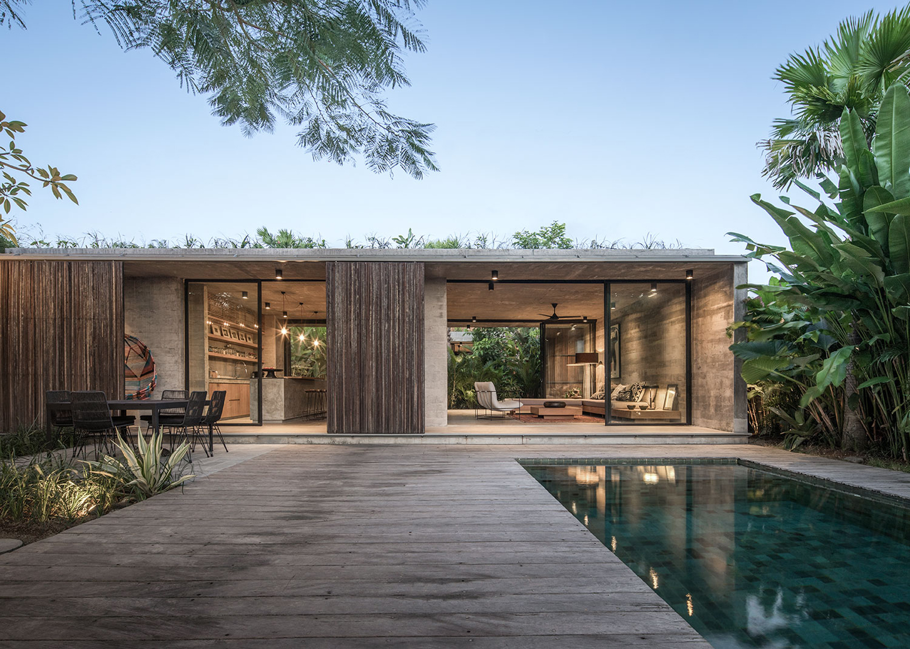 caceres + tous sets exposed concrete 'house BK' amid bali's lush natural landscape