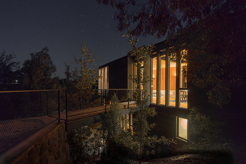 hsu-rudolphy arquitectos embeds 'slope house' into the banks of chile's rapel lake