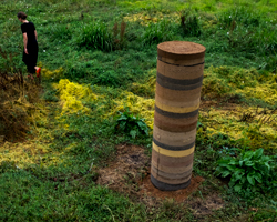 pillars made from the biomass of dead palm trees populate a riverside site in portugal