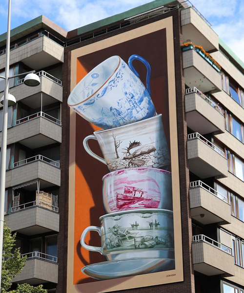 fragile teacups tumble out of a building in leon keer's ‘shattering’ 3D mural in sweden