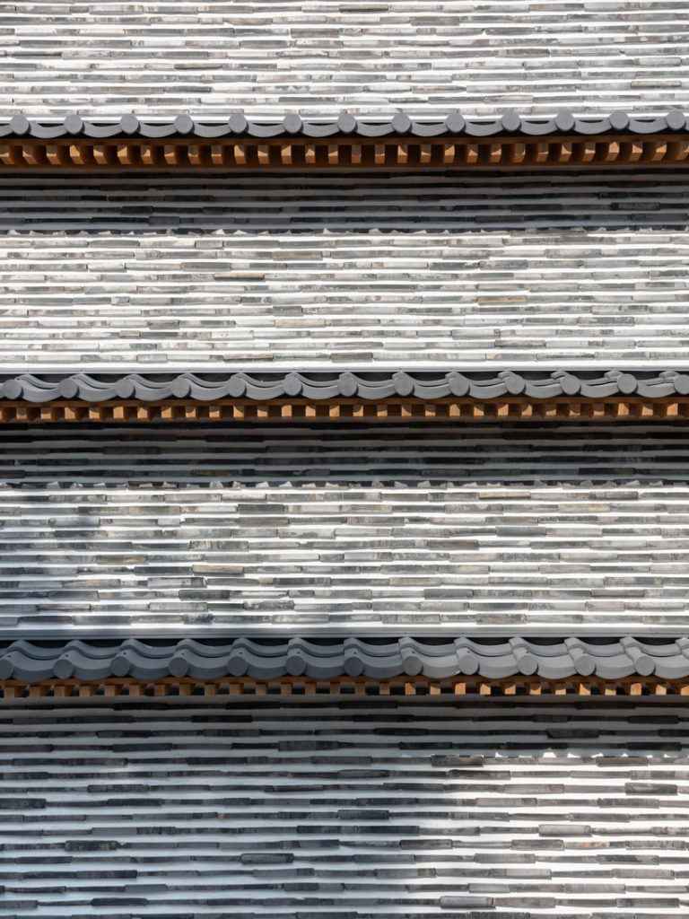love architecture adds concrete + wood hall for tree burials to new