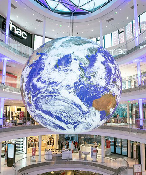 luke jerram + tetro put parisian shopping mall into orbit with globe installation