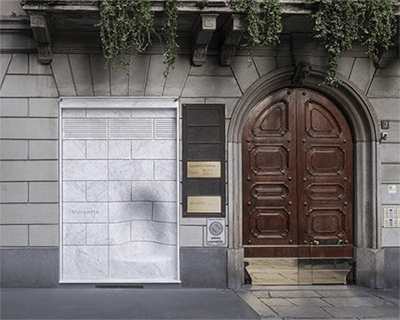 nendo mines impromptu marble bench in façade of marsotto's brera showroom