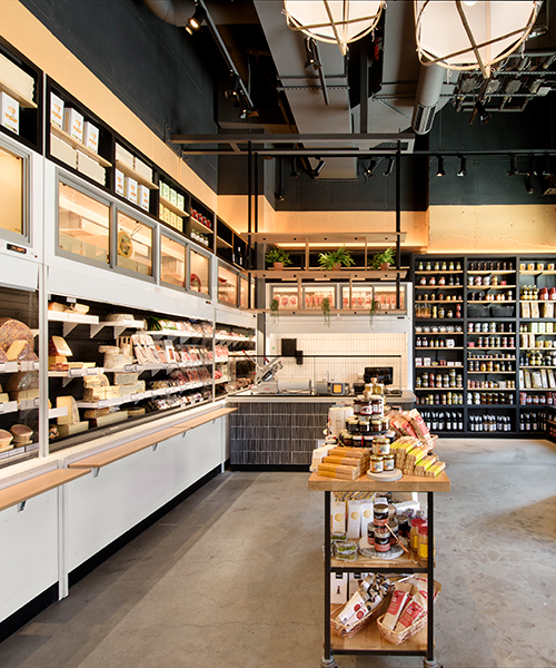rockwell group designs library-like murray's cheese shop & cheese bar in long island