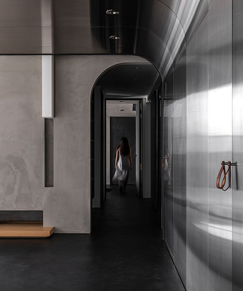 stainless steel wall reflects daily life within minimalist interior by studioX4 in taipei