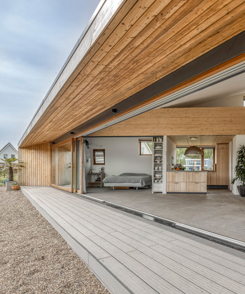large sliding door merges exterior & interior of 'south house' in the netherlands