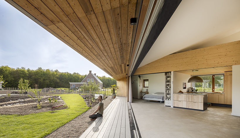 large sliding door merges exterior & interior of 'south house' in the netherlands