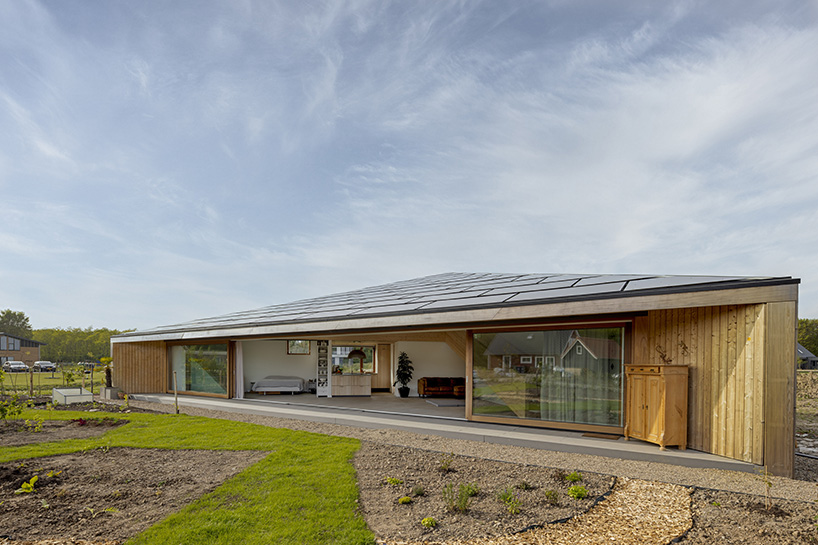 large sliding door merges exterior & interior of 'south house' in the netherlands