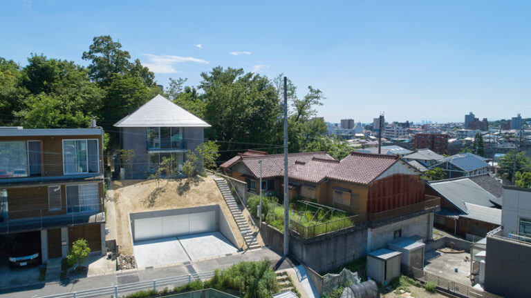 airhouse tops house on a sloping hill in seto, japan, with pyramid hip roof