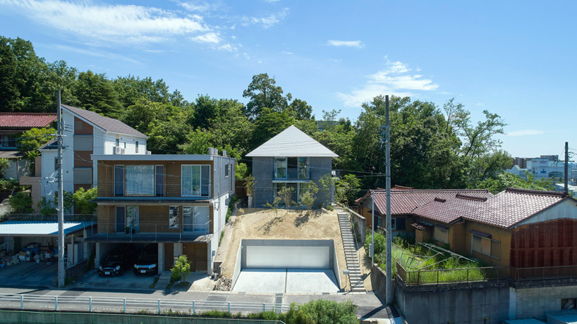 airhouse tops house on a sloping hill in seto, japan, with pyramid hip roof