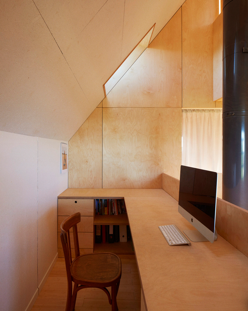 arba is building a wooden house between two old stone walls in rural france