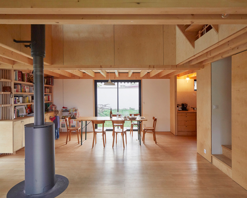 arba is building a wooden house between two old stone walls in rural france