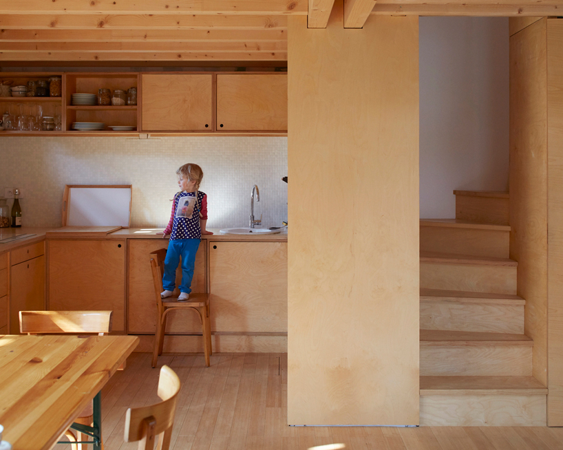 arba is building a wooden house between two old stone walls in rural france