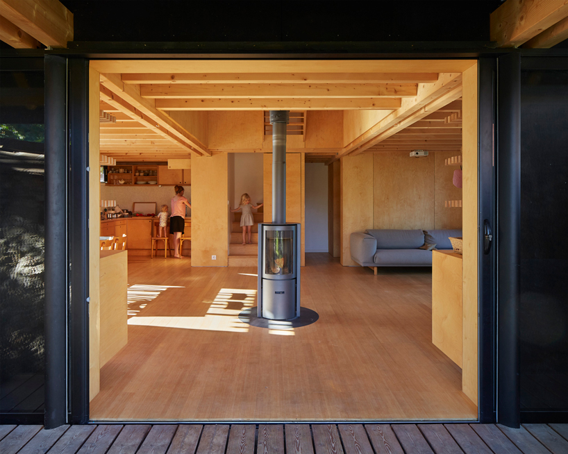 arba is building a wooden house between two old stone walls in rural france