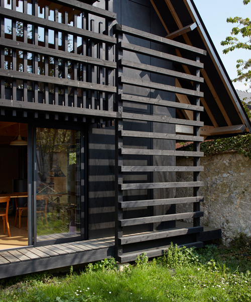 arba builds a timber house between two old stone walls in rural france