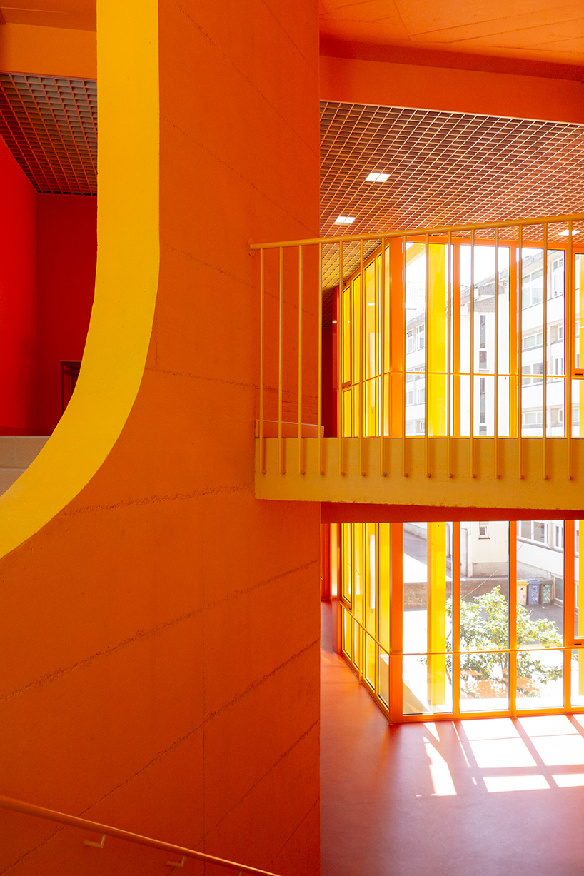aurora arquitectos connects music school in portugal with vibrant yellow intervention
