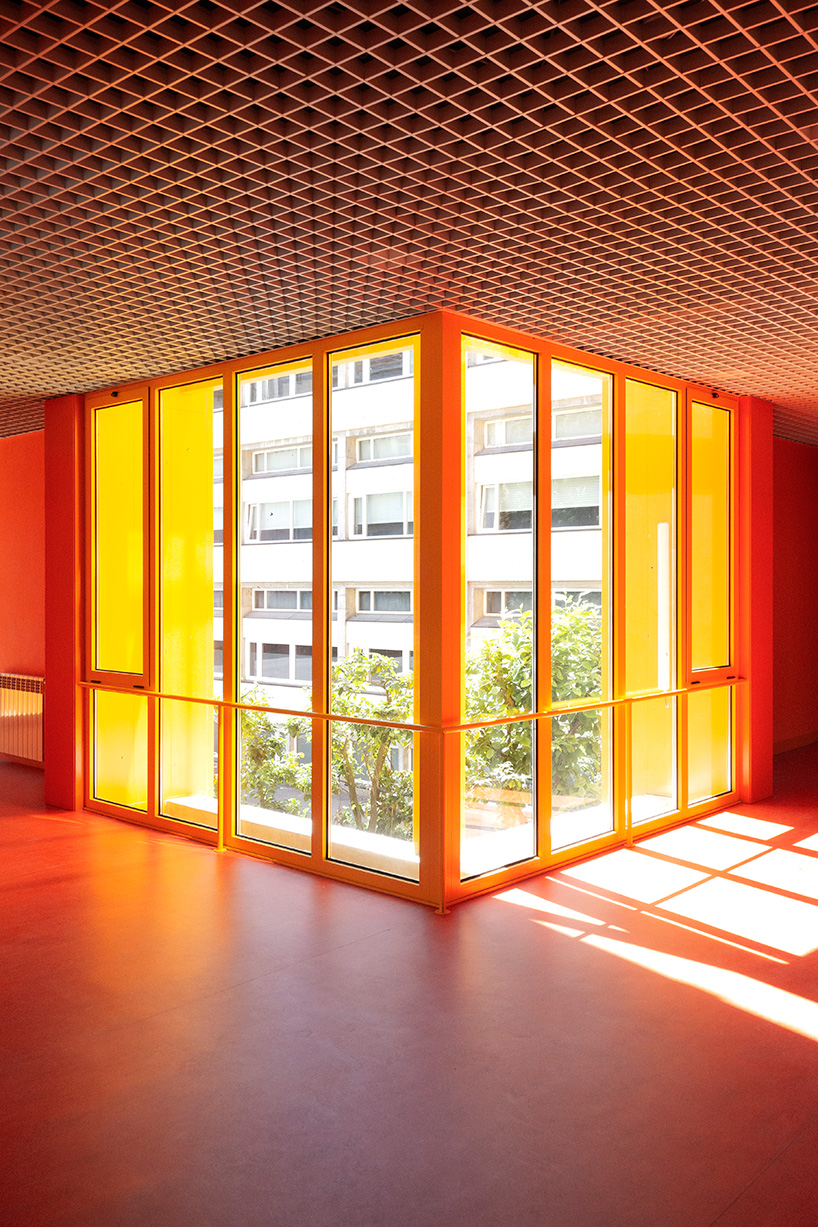aurora arquitectos connects music school in portugal with vibrant yellow intervention