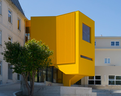aurora arquitectos connects music school in portugal with vibrant yellow intervention