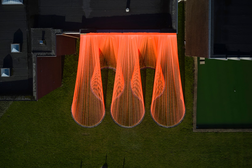 two bright orange, mesh fabric installations by behin ha pop up in denmark