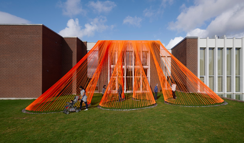 two bright orange, mesh fabric installations by behin ha pop up in denmark