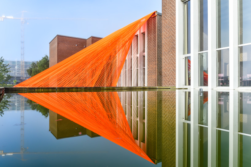 two bright orange, mesh fabric installations by behin ha pop up in denmark