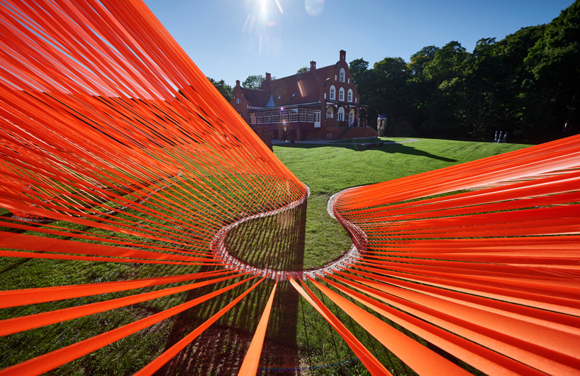 two bright orange, mesh fabric installations by behin ha pop up in denmark