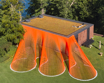 two bright orange, mesh fabric installations by behin ha pop up in denmark