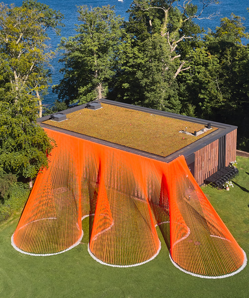 two bright orange, mesh fabric installations by behin ha pop up in denmark