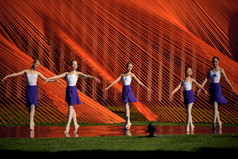 two bright orange, mesh fabric installations by behin ha pop up in denmark