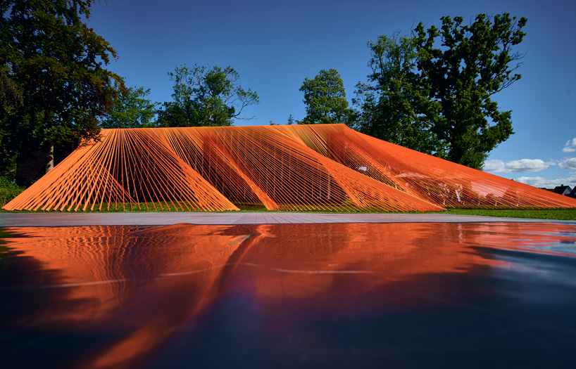 two bright orange, mesh fabric installations by behin ha pop up in denmark