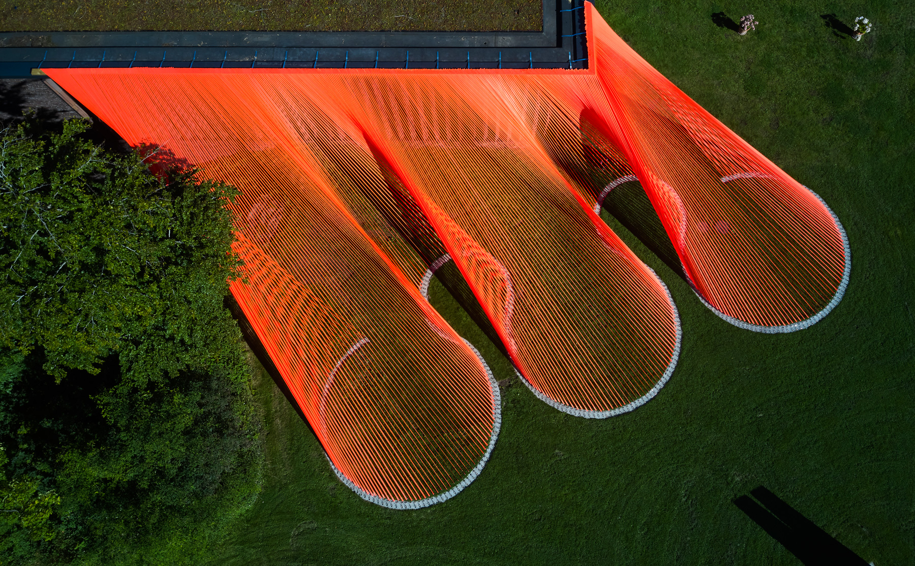 two bright orange, mesh fabric installations by behin ha pop up in denmark