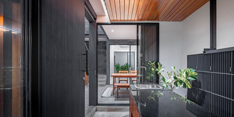 bodinchapa architects clads thai house + family business building in brick and wood façade