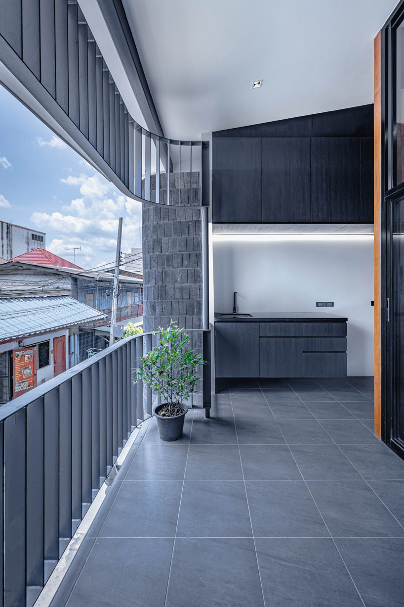 bodinchapa architects clads thai house + family business building in brick and wood façade