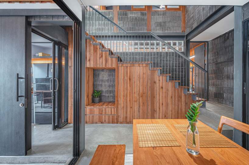 bodinchapa architects clads thai house + family business building in brick and wood façade