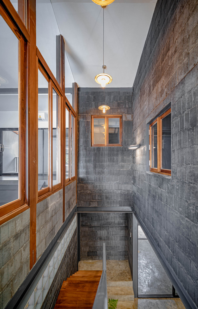 bodinchapa architects clads thai house + family business building in brick and wood façade