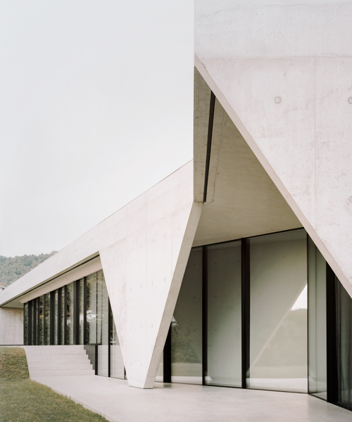 studio colleoni previtali wraps its 'creek house' in a skin of austere concrete