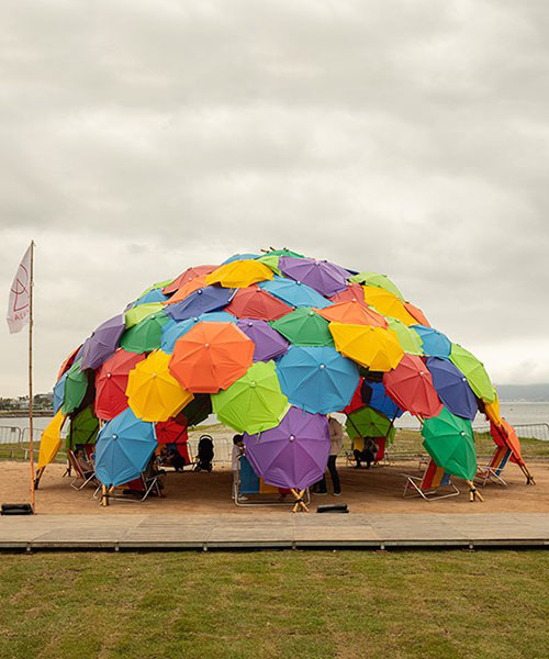 dome installation made out of colorful umbrellas decorates beach on brazil