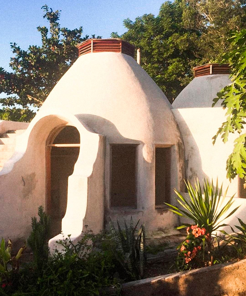 eco-village of clustered 'lombok domes' accumulates along indonesian coastline