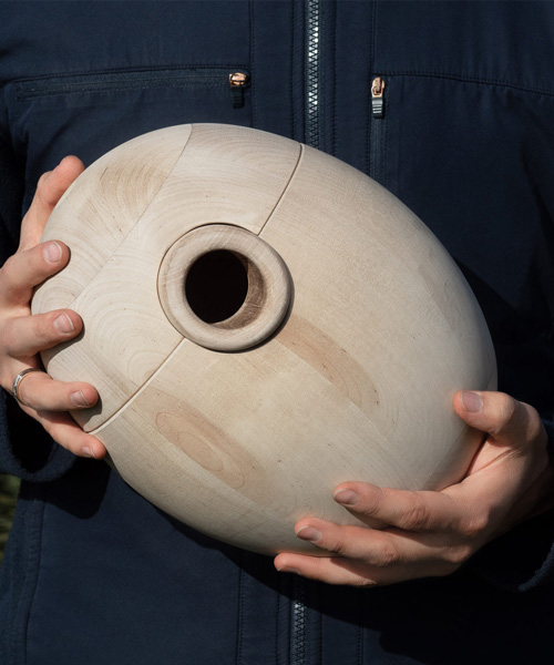 dydykin studio designs round wooden birdhouse to resemble a natural tree hollow