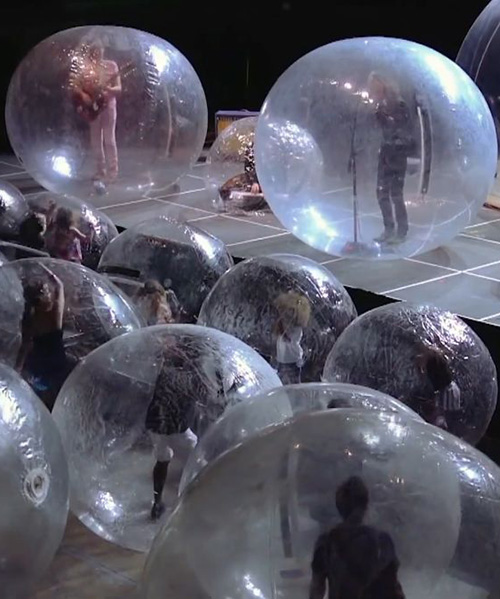 the flaming lips perform a concert with both the band and fans encased in plastic bubbles