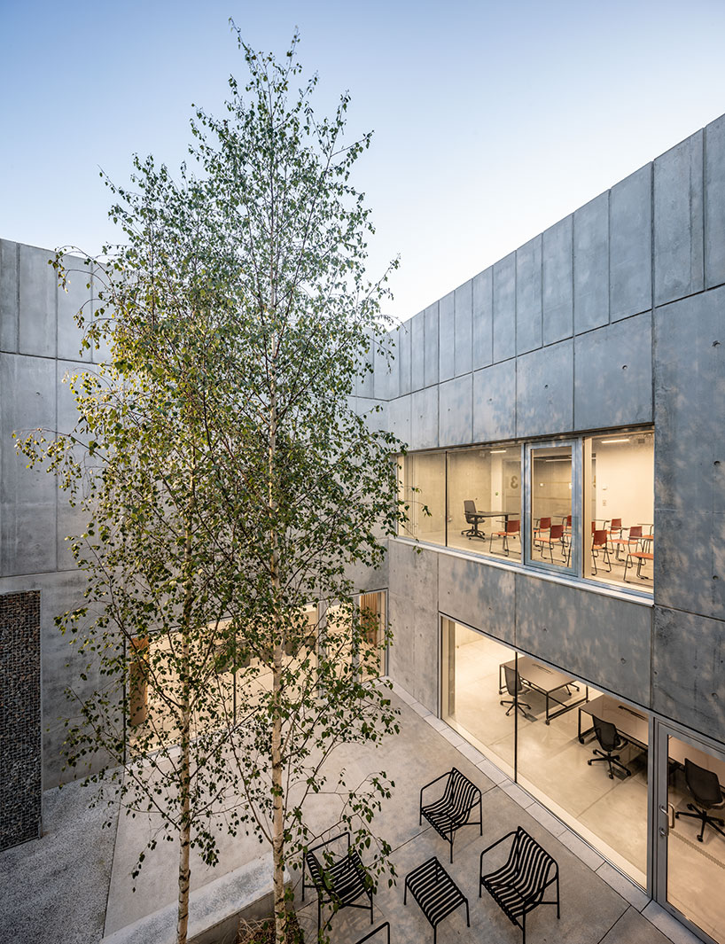 randja architects completes robust stone & concrete technology park in france