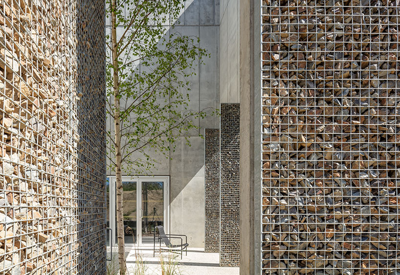 randja architects completes robust stone & concrete technology park in france