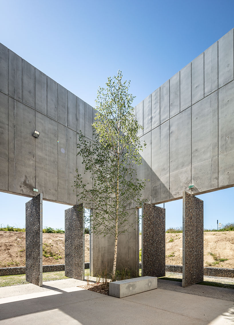 randja architects completes robust stone & concrete technology park in france