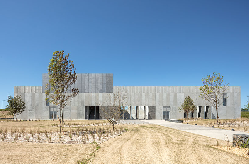 randja architects completes robust stone & concrete technology park in france