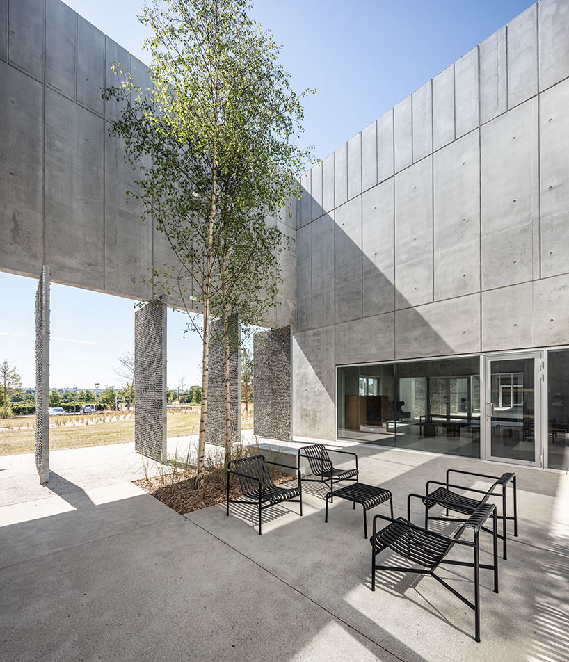 randja architects completes robust stone & concrete technology park in france