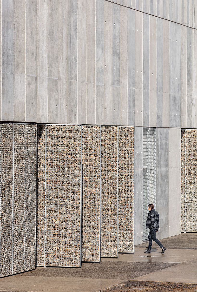 randja architects completes robust stone & concrete technology park in france