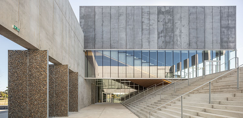 randja architects completes robust stone & concrete technology park in france